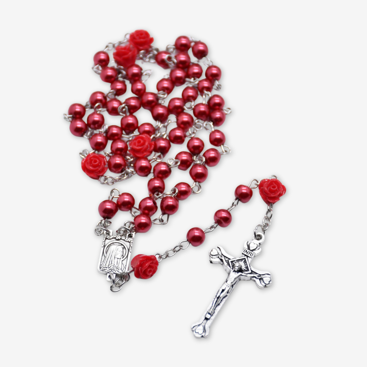 Rosario con perle rosse e rose.