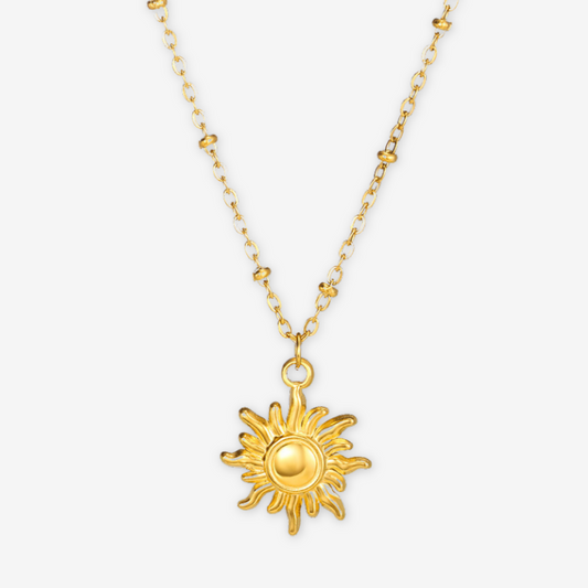 Collana con perle dorate e medaglione con sole