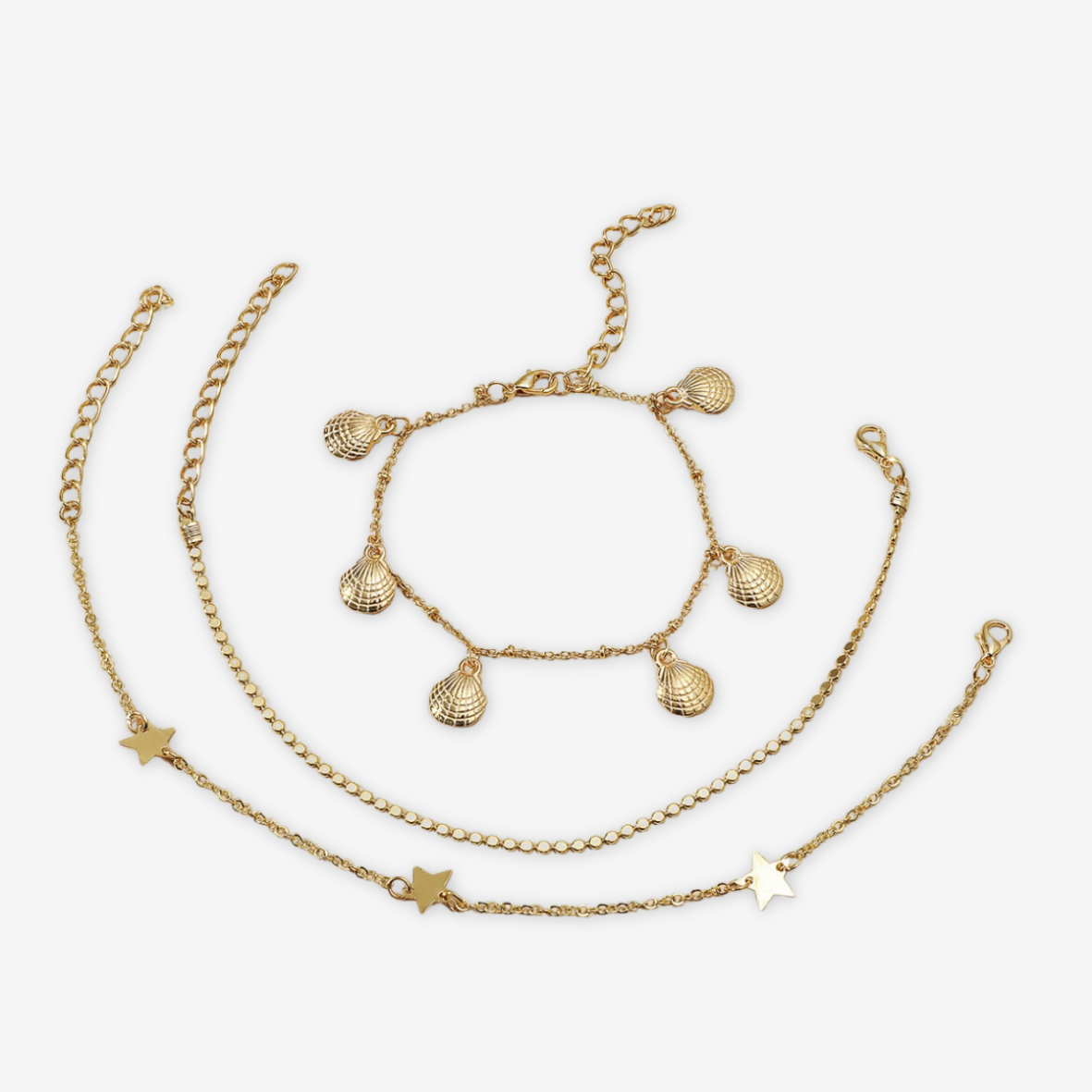 Tris bracciali conchiglie/stelle dorati